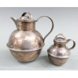 Two hallmarked silver Guernsey cream jugs, one Birmingham 1964 height 8cm the other smaller