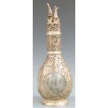 Hong Kong white metal mounted four compartment decanter, with pierced and embossed prunus