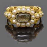 Georgian mourning ring set with plaited hair to the centre surrounded by seed pearls, with