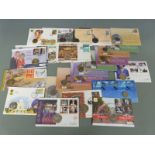 Twenty four UK and world coin and stamp cover sets including RAF, Berlin Airlift, Ireland, Australia