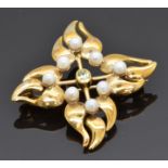 A 9ct gold brooch set with peridot and pearls in a stylised foliate design, 7.7g