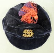 A 19thC velvet sporting or scholar's cap with gold thread 'SMM' and blue and red tassel