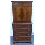 Mahogany secretaire chest of two over four drawers either side of a cabinet, opening to reveal a