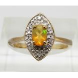 A 9ct gold ring set with an oval cut Indonesian opal and diamonds, 2.4g, size N