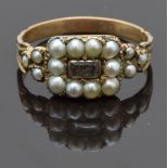 Victorian mourning ring set with hair to the centre surrounded by seed pearls, size O, 2.00g