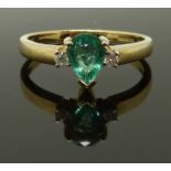 A 9ct gold ring set with a pear cut emerald and diamonds, size N, 2.18g