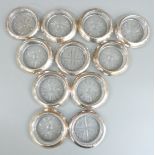 Set of eight white metal mounted glass coasters, each marked Frank Whitting & Co. Sterling, together