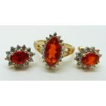 A pair of 9ct gold earrings set with oval cut Queretaro cherry fire opals and white sapphires and