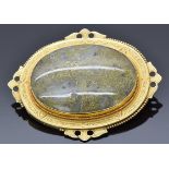 Victorian yellow metal brooch set with a gold veined quartz cabochon within an engraved border, 5.
