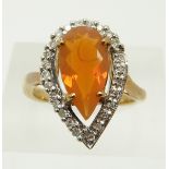 A 9ct gold ring set with a pear cut fire opal and diamonds, 4.4g, size N