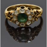 An early Victorian ring set with a cushion cut emerald of approximately 0.5ct surrounded by old