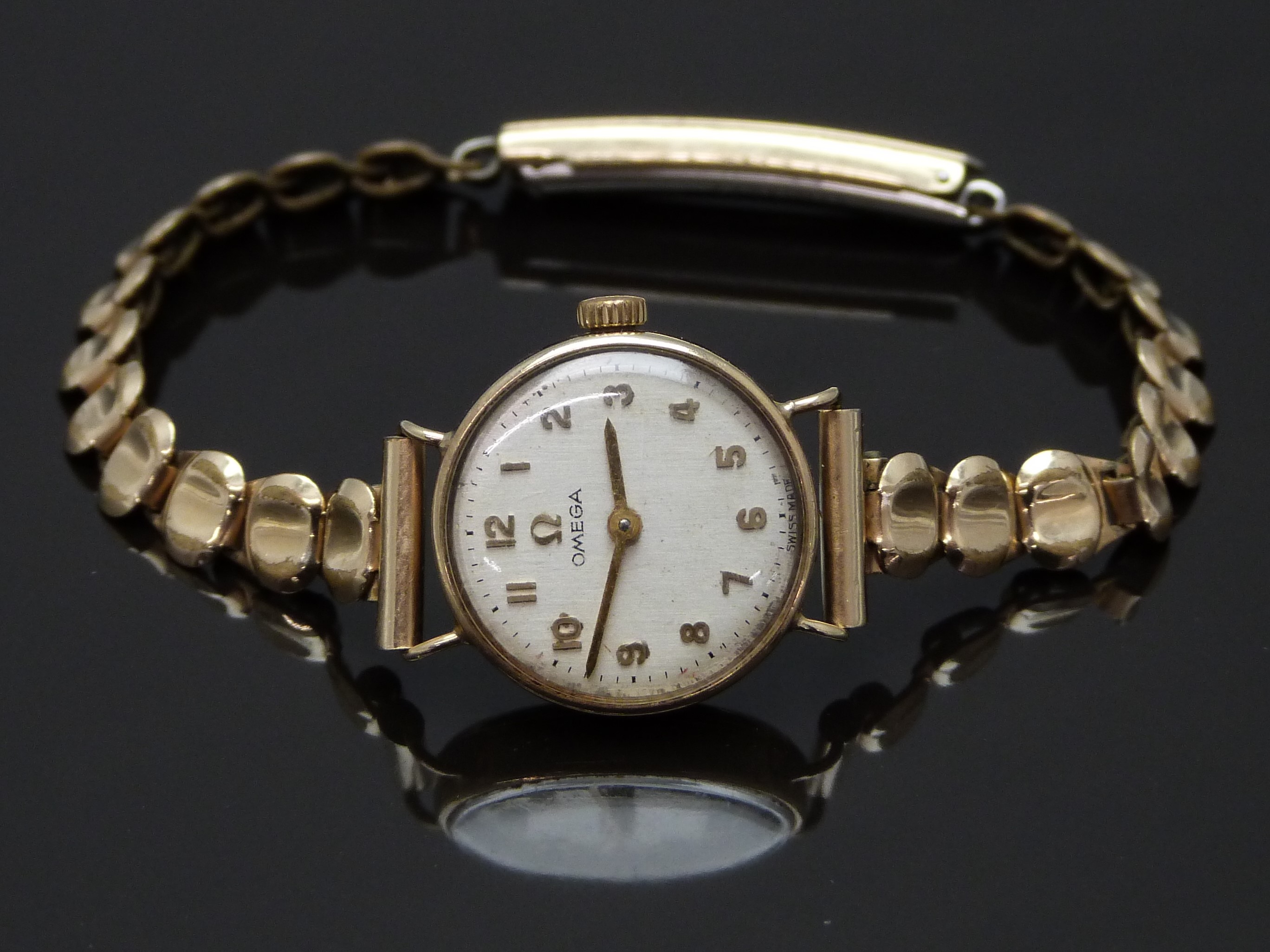 Omega 9ct gold ladies wristwatch ref.7115500 with gold hands and Arabic numerals, silver dial and