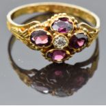 Victorian 9ct gold ring set with an old cut diamond surrounded by garnets, with engraved band and