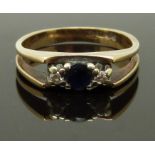 A 9ct gold ring set with a sapphire and diamonds, size J, 2.45g