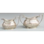 Hallmarked silver sugar bowl and milk jug with reeded lower bodies and gadrooned edge, Birmingham,