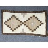North American First Nation rug with geometric brown design on a beige ground, 95 x 52cm