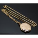A 9ct gold locket with engraved decoration on 9ct gold chain, 6.3g