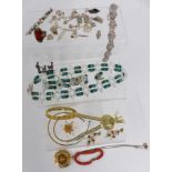 A collection of jewellery including silver brooch, silver charm bracelet, paste bracelet, silver