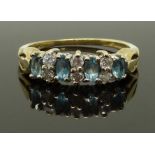 A 9ct gold ring set with aquamarines and diamonds, size L, 1.85g