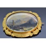 Victorian pinchbeck brooch set with a painted mother of pearl plaque depicting a seascape, 5 x 4.2cm