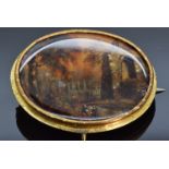 Victorian pinchbeck brooch set with a painted mother of pearl plaque depicting a landscape, 5 x 4cm