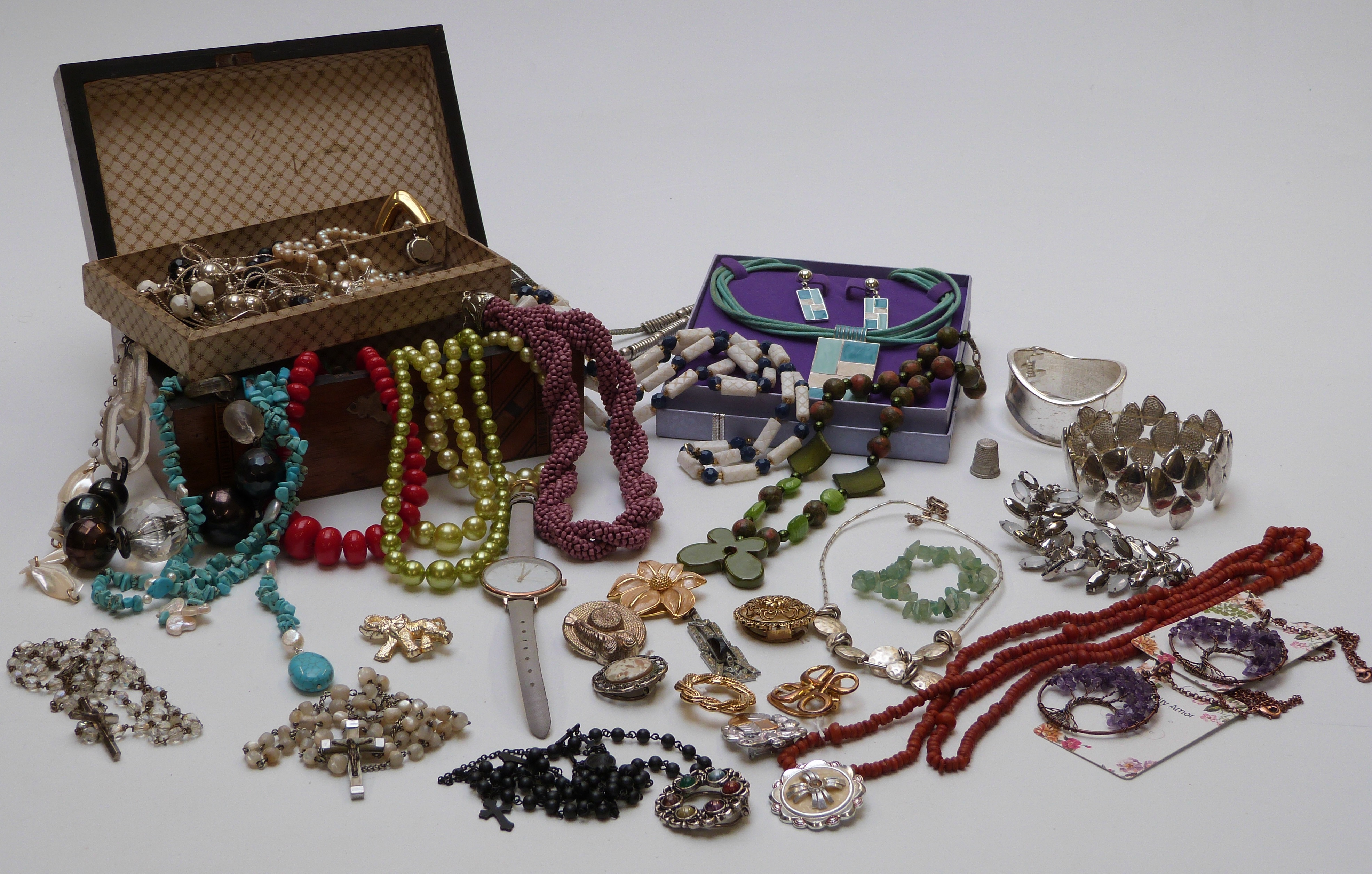 A collection of costume jewellery including turquoise, brooches, amethyst, necklaces, etc