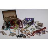 A collection of costume jewellery including turquoise, brooches, amethyst, necklaces, etc