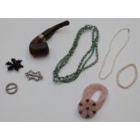 A large collection of costume jewellery including beads, bangles, brooches, rose quartz necklace,