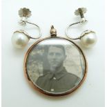 A pair of 9ct white gold earrings set with a pearl to each and an Edwardian locket with 9ct gold
