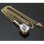 A 9ct gold pendant set with an oval mixed cut morganite and diamonds on a 9ct gold chain, 6.2g
