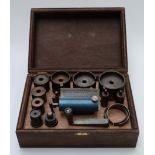 A clock spring winding tool set in wooden case