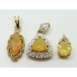 Three 9ct gold pendants set with opals