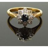 An 18ct gold ring set with a sapphire and diamonds in a flower setting, size J, 3.33g