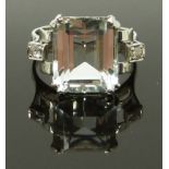 A 14ct white gold ring set with an emerald cut aquamarine and two diamonds, size M, 4.58g