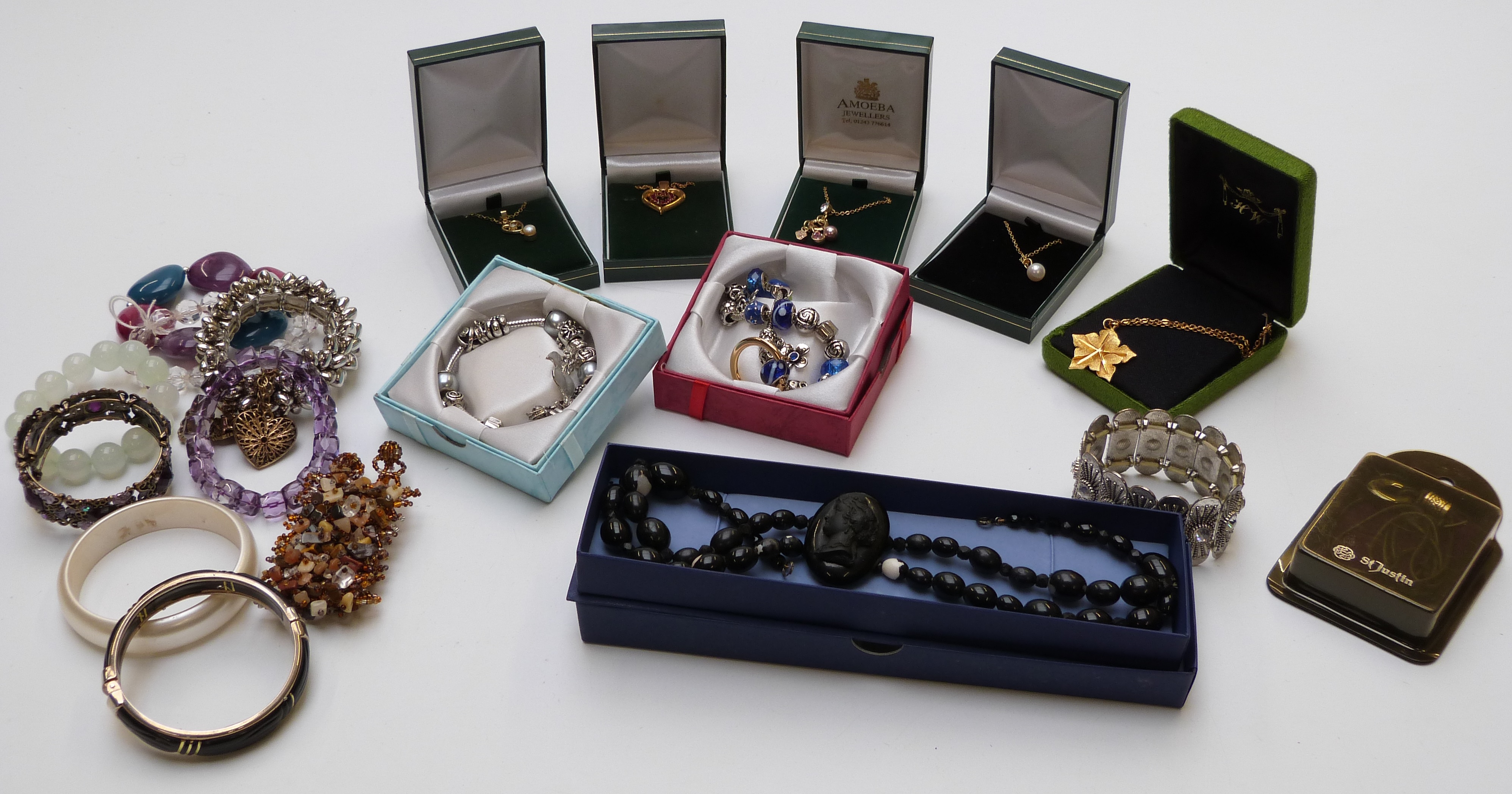 A collection of costume jewellery including beads, necklaces, brooches, etc