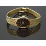 Eterna 14ct gold ladies wristwatch with white hands and baton markers, chocolate dial and signed
