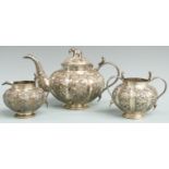 Indian or Burmese white metal three piece teaset with lobed embossed decoration, snake handles and