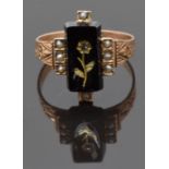 Victorian ring set with an onyx panel engraved with a gold flower, set with a diamond, with engraved