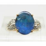 A 9ct gold ring set with an oval boulder opal cabochon of approximately 2.2cts and zircons, 2g, size