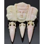A 19thC Greco Roman carved coral brooch depicting portraits and amphora, 4.6 x 6cm