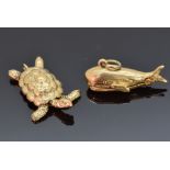 A 9ct gold charm depicting a whale opening to reveal Jonah and a 9ct gold charm depicting a