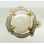 A 9ct gold ring set with a large oval opal cabochon and diamonds, 3.3g, size N