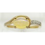 A 9ct gold ring set with an oval opal cabochon and diamonds, 2g, size N