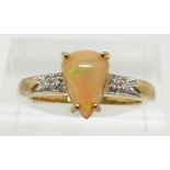 A 9ct gold ring set with a pear cut Indonesian opal and diamonds, 2.8g, size N