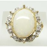 A 9ct gold ring set with an oval Coober Pedy opal cabochon and white sapphires, 7.5g, size N