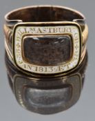Georgian mourning ring set with plaited hair in a glass compartment with white enamel border reading