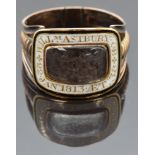 Georgian mourning ring set with plaited hair in a glass compartment with white enamel border reading