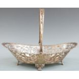 George V hallmarked silver swing handled basket with pierced decoration, raised on four paw feet,