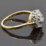 An 18ct gold ring set with a central diamond of approximately 0.5ct surrounded by six further 0.08ct