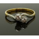 An 18ct gold ring set with two diamonds in a platinum setting, size Q, 2.46g